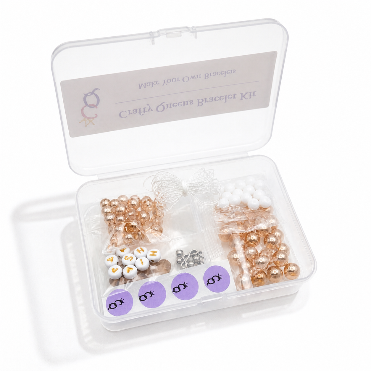open bracelet making kit with champagne gold beads, white iridescent beads, letter beads, and elastic cord in storage box
