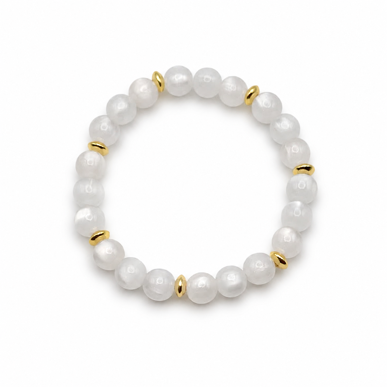 UV color changing bracelet with photochromic cat’s eye beads under room light, appearing cream-white with gold spacer beads and stretch cord