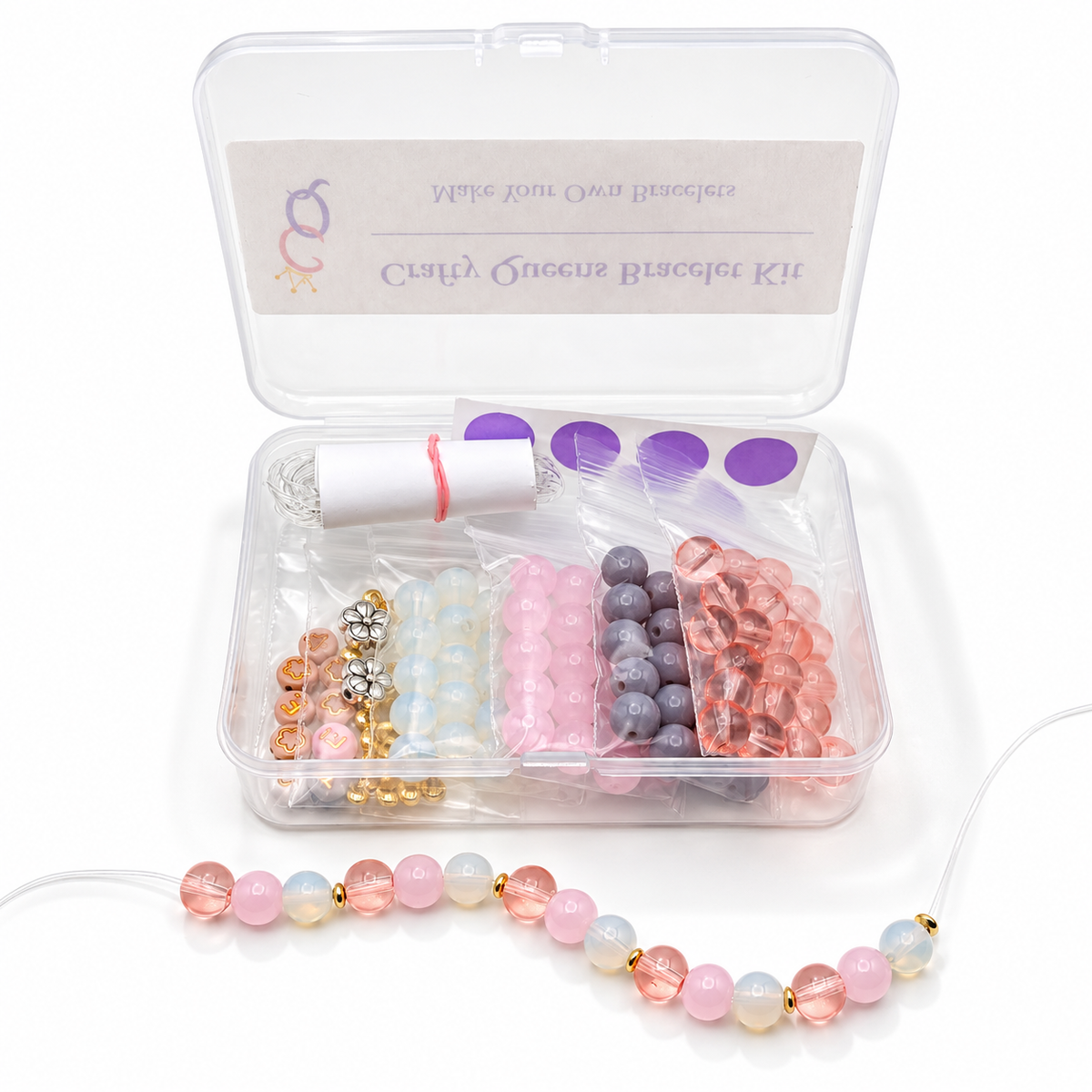Blush Pop bracelet kit with pink, peach, mauve, and pearly white glass beads, letter beads, floral charms, and bracelet-making supplies