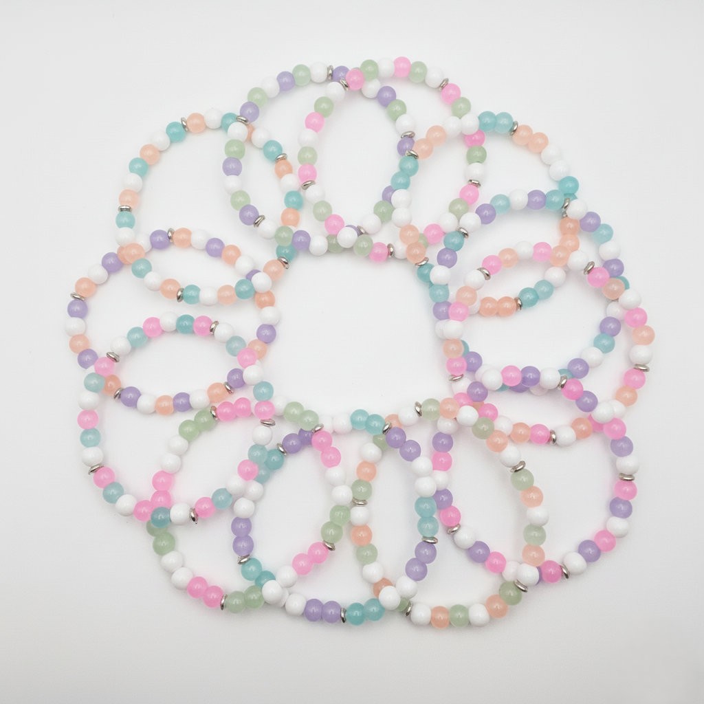 12-piece pastel glass bead bracelet party favor set arranged in circular layout, 6mm stretch bracelets in pink, peach, mint, aqua, lavender and white for kids