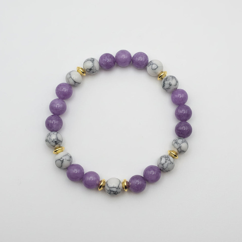 colorful 8mm purple mica and white howlite gemstone bracelet with gold spacer accents and stretch cord for polished everyday style