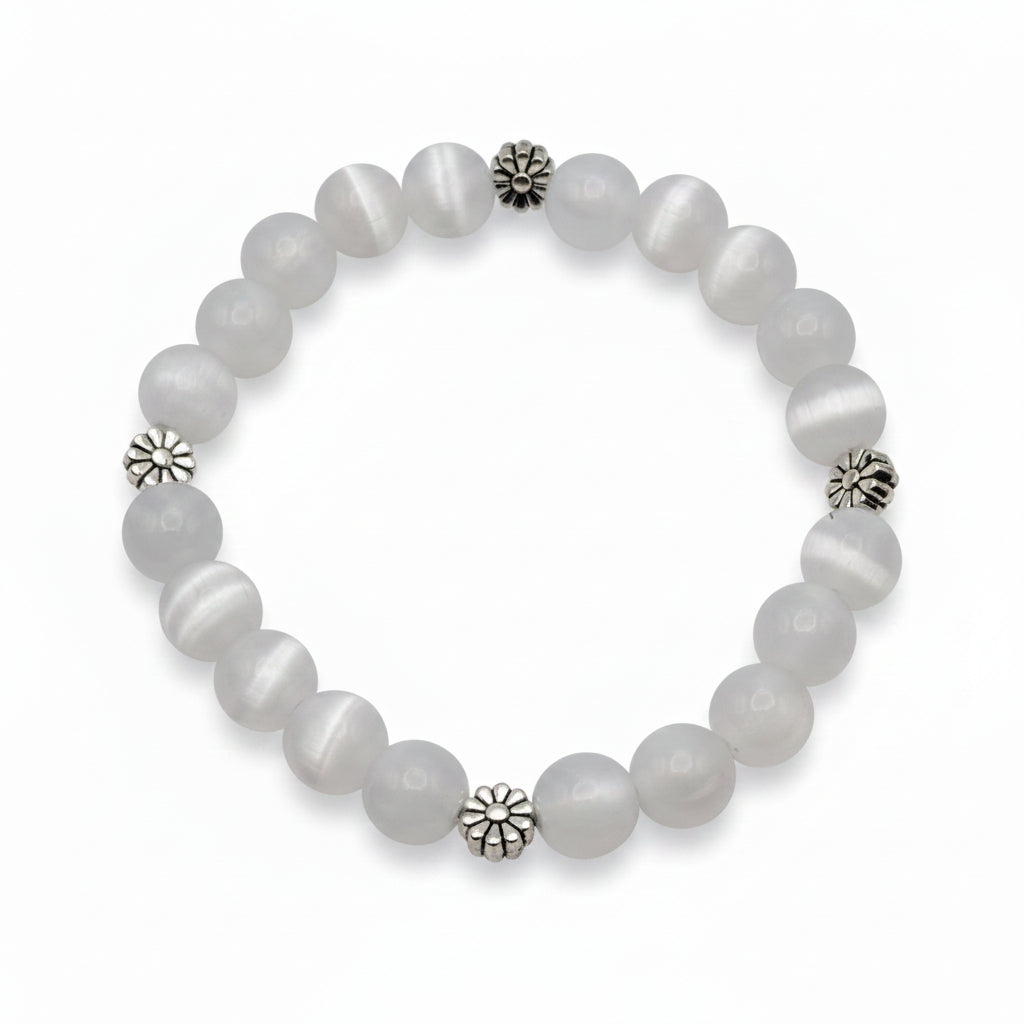 UV color changing bracelet with photochromic cat’s eye beads under room light, appearing cream-white before sunlight exposure, featuring daisy-inspired metal spacers and stretch cord