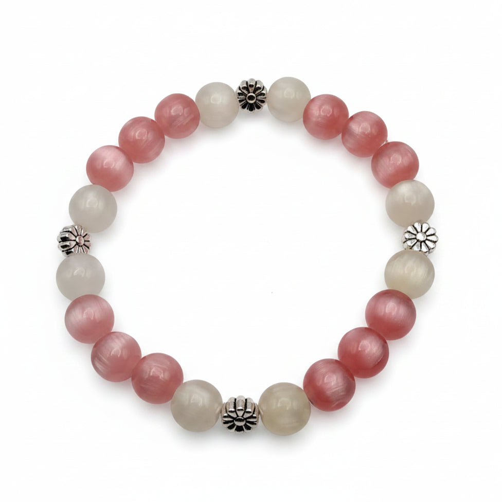 UV color changing bracelet with photochromic cat’s eye beads that transform from cream tones to blush pink and yellow hues in sunlight, featuring daisy-inspired metal spacers and stretch cord