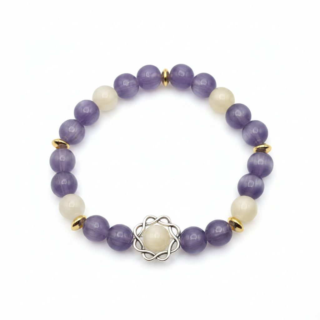UV color changing bracelet with photochromic cat’s eye beads transformed into radiant lavender hues in sunlight, featuring gold spacer beads, decorative metal centerpiece