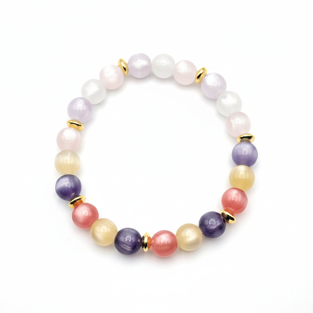 UV color changing bracelet with photochromic cat’s eye beads showing lavender, blush pink, yellow, and cream tones during sunlight exposure, accented with gold spacer beads