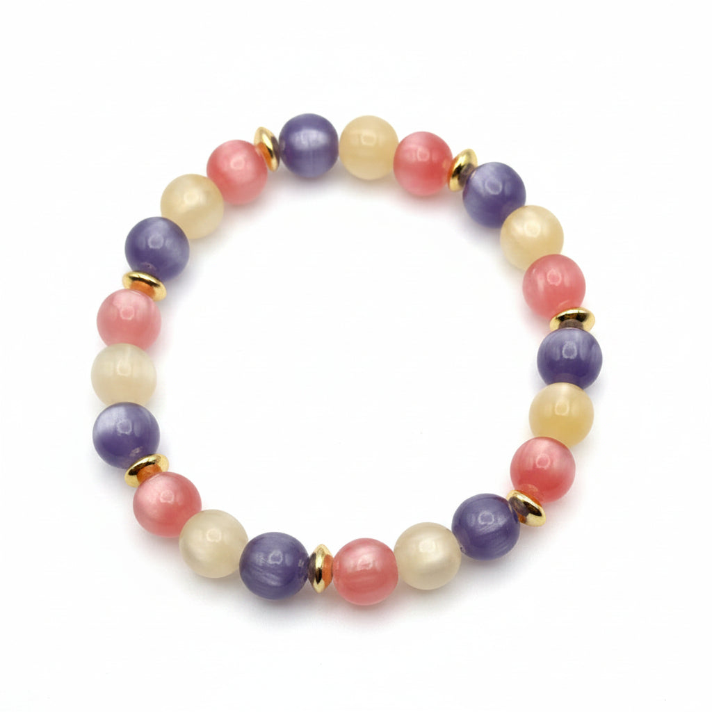 UV color changing bracelet with photochromic cat’s eye beads transformed into lavender, blush pink, and yellow hues in sunlight, featuring gold spacer beads and stretch cord