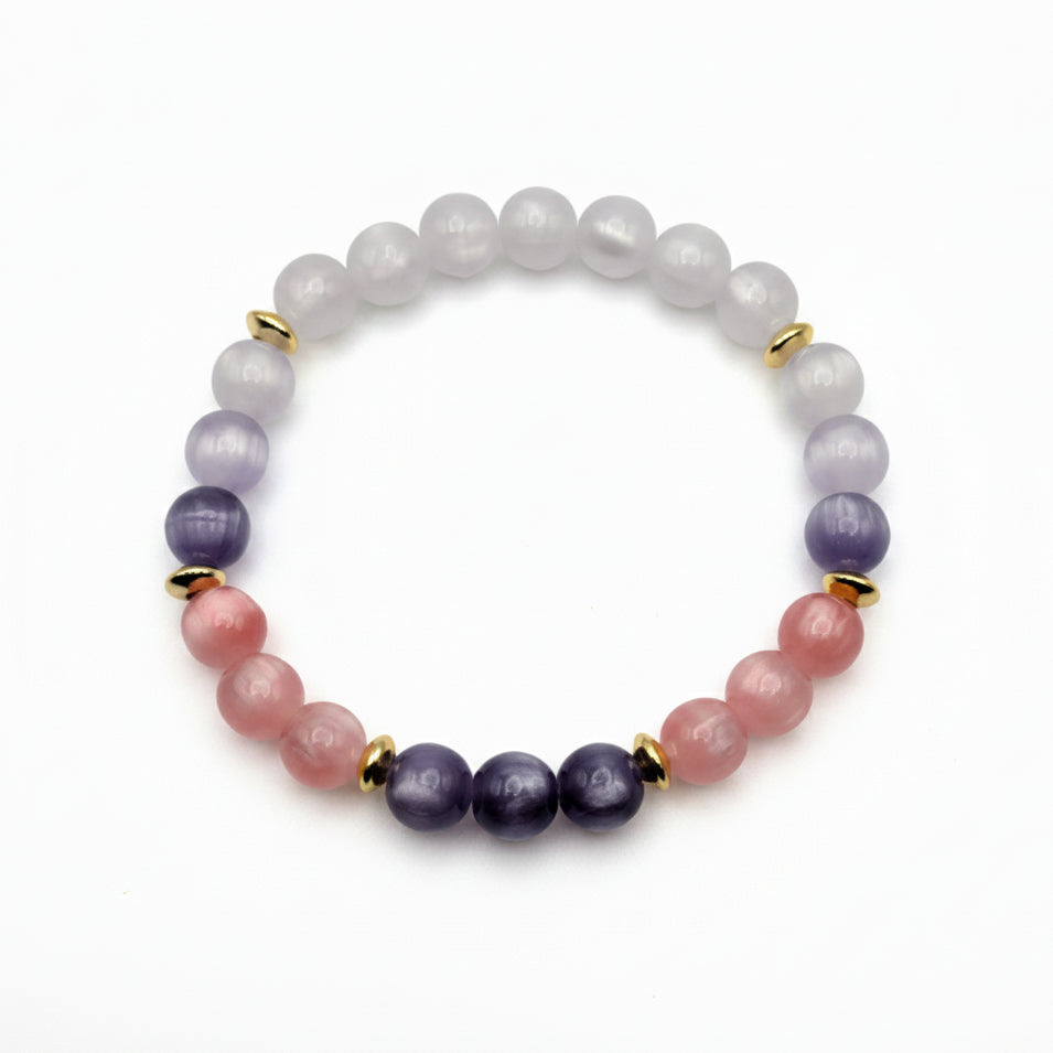 UV color changing bracelet with photochromic cat’s eye beads showing berry pink, lavender, and cream tones during sunlight exposure, accented with gold spacer beads