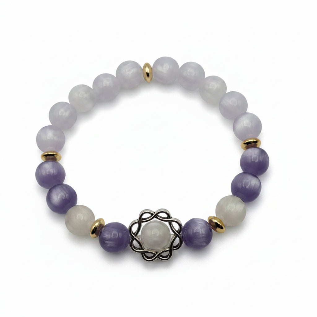UV color changing bracelet with photochromic cat’s eye beads showing lavender and cream tones during sunlight exposure, featuring gold spacer beads and decorative metal centerpiece
