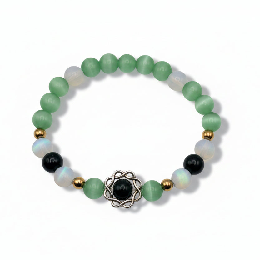 Green 8mm glass bead stretch bracelet with cat’s-eye and milky opalescent beads, golden spacers, and framed dark green center bead