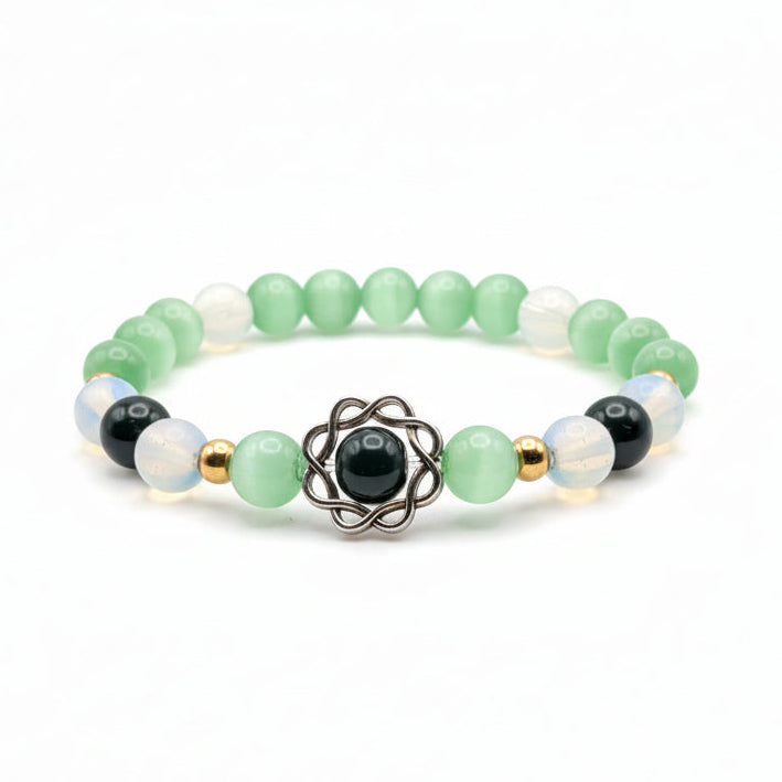Green 8mm glass bead stretch bracelet with cat’s-eye and milky opalescent beads, golden spacers, and framed dark green center bead