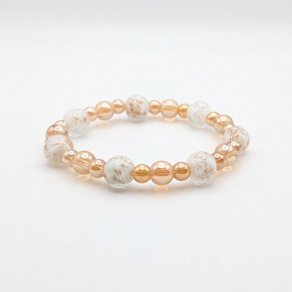 Golden Firefly glass bead stretch bracelet with champagne-toned beads and translucent 10mm lampwork beads with milky white centers and golden flecks